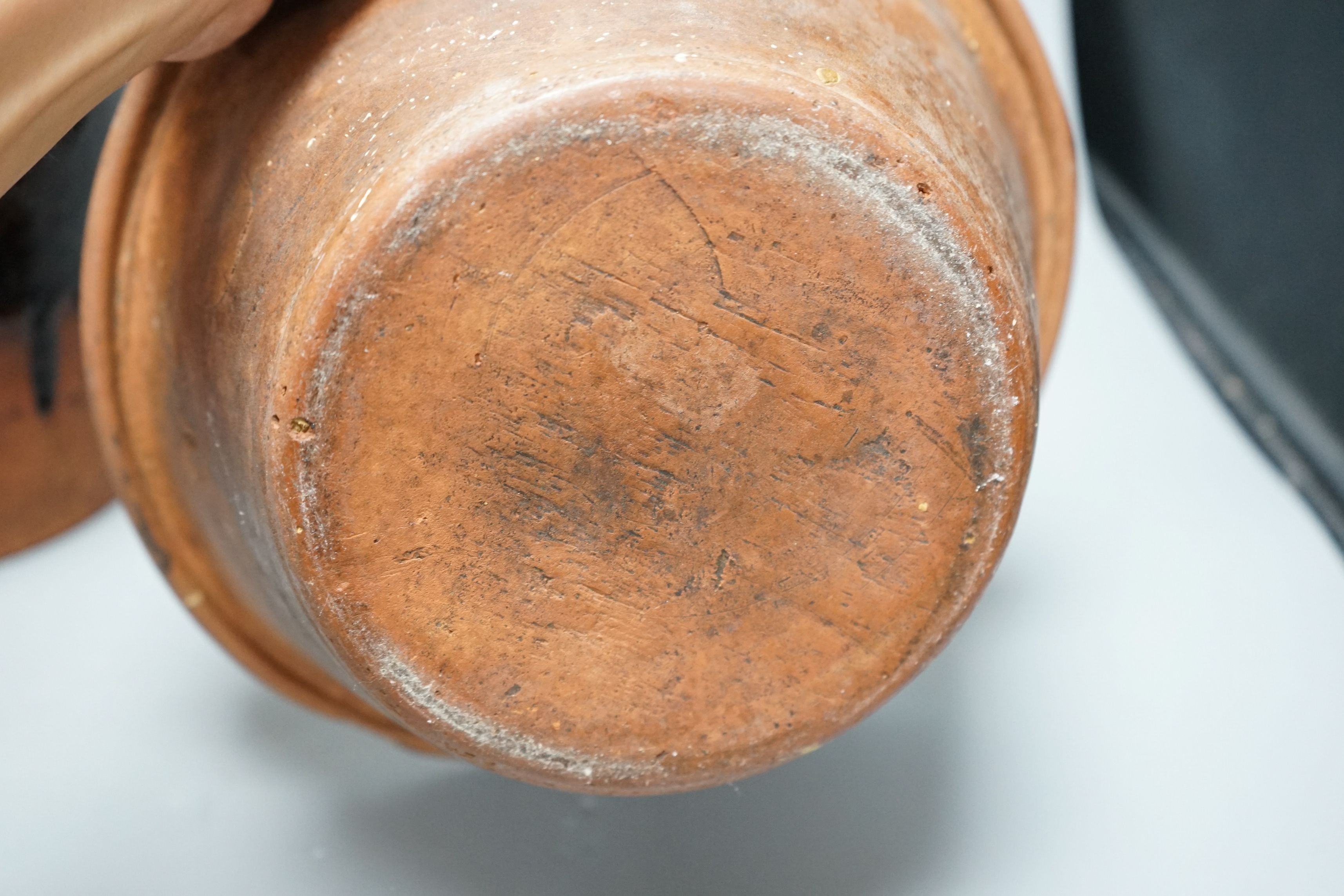 A 19th century slipware bowl and brown glazed single handled storage jar, 21cm tall, (2)